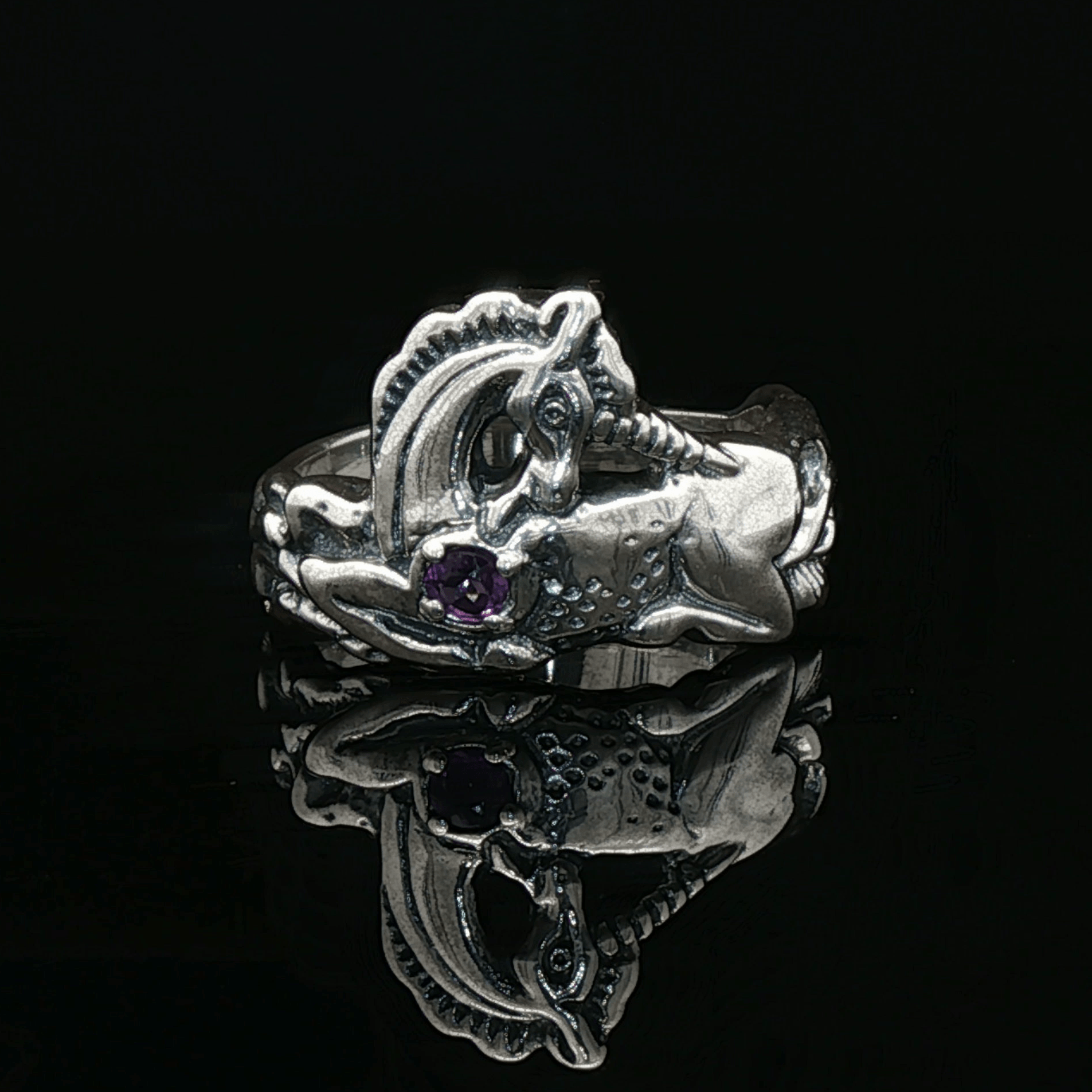 A detailed sterling silver unicorn ring with a vibrant gemstone heart, designed for lovers of unicorn jewelry and fantasy-inspired accessories by Le Dragon Argenté.