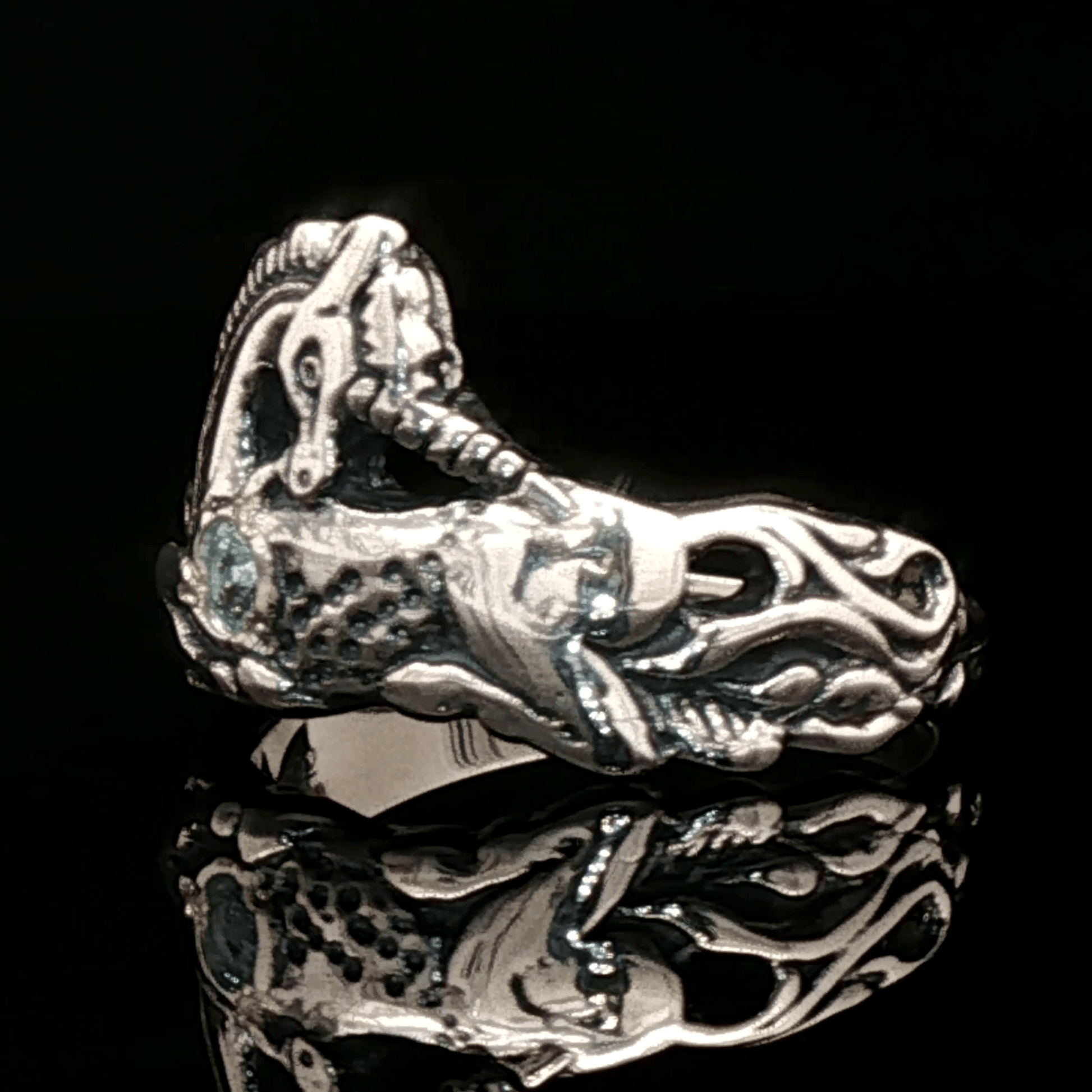 A detailed sterling silver unicorn ring with a vibrant gemstone heart, designed for lovers of unicorn jewelry and fantasy-inspired accessories by Le Dragon Argenté.