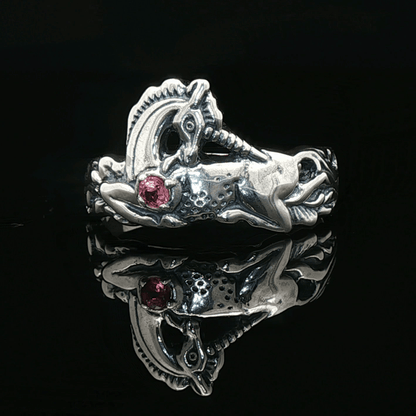 A detailed sterling silver unicorn ring with a vibrant gemstone heart, designed for lovers of unicorn jewelry and fantasy-inspired accessories by Le Dragon Argenté.