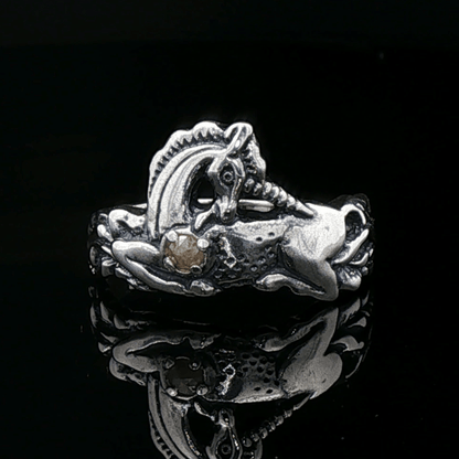 A detailed sterling silver unicorn ring with a vibrant gemstone heart, designed for lovers of unicorn jewelry and fantasy-inspired accessories by Le Dragon Argenté.