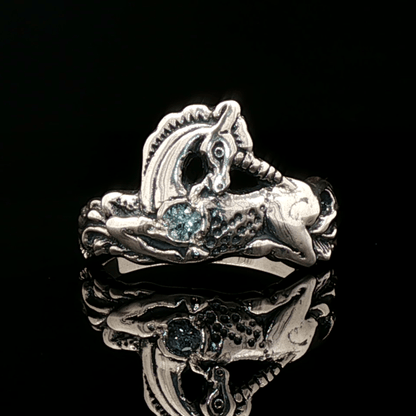 A detailed sterling silver unicorn ring accented with a colorful imitation birthstone heart, ideal for fans of unicorn jewelry and fantasy-inspired accessories by Le Dragon Argenté.